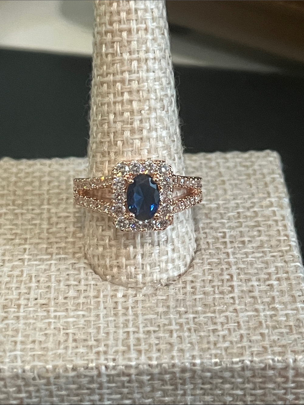 Rose Gold Ring with Deep Blue Oval Center and Halo
